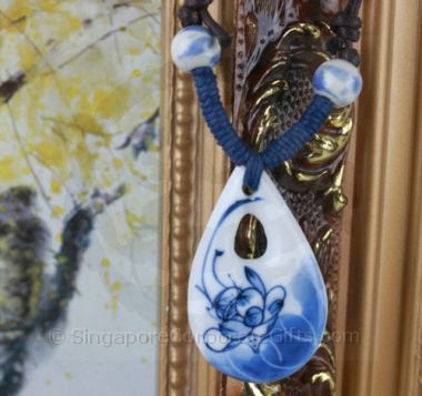 White ceramic with blue lotus necklace